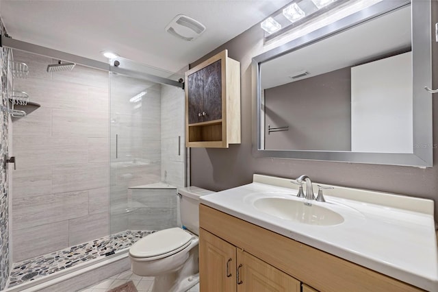 bathroom with a shower with door, vanity, and toilet