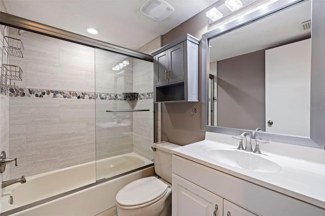 full bathroom with toilet, enclosed tub / shower combo, and vanity