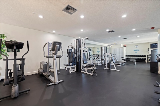 workout area featuring a textured ceiling