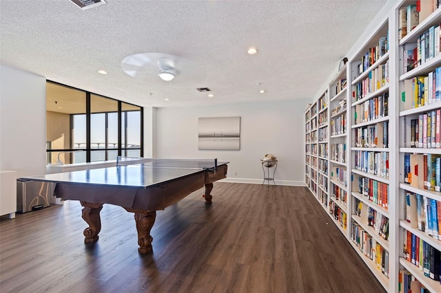 playroom featuring dark hardwood / wood-style flooring, a textured ceiling, and expansive windows