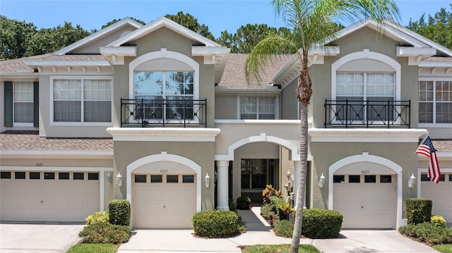 multi unit property featuring a garage and a balcony