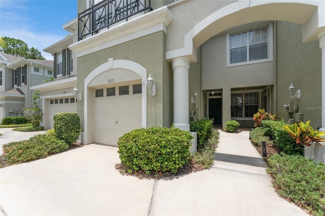 view of front of property with a balcony and a garage