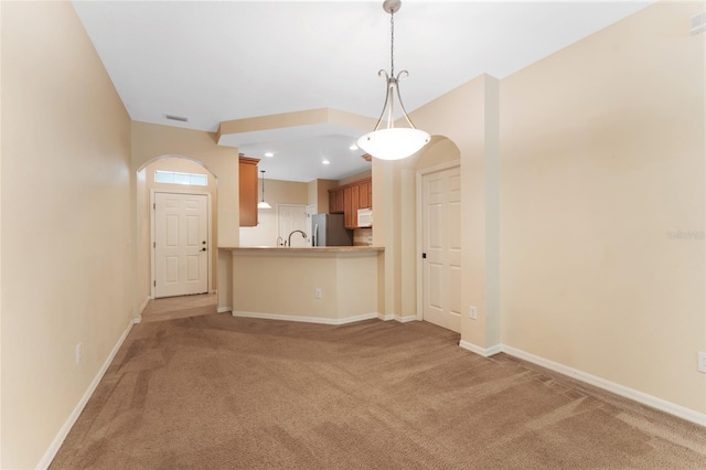 unfurnished living room featuring light colored carpet