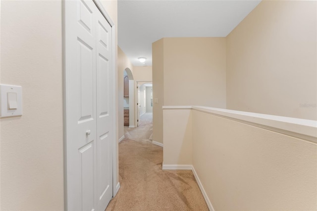 corridor featuring light colored carpet