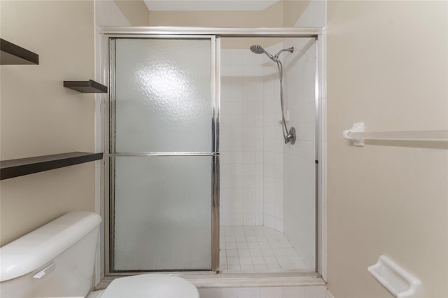 bathroom with an enclosed shower and toilet