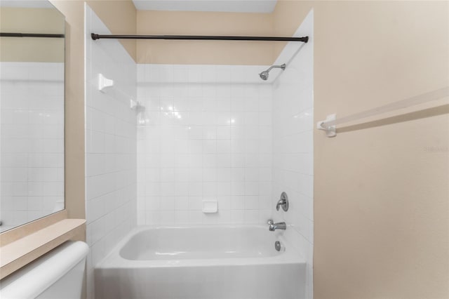 bathroom featuring shower / bath combination and toilet