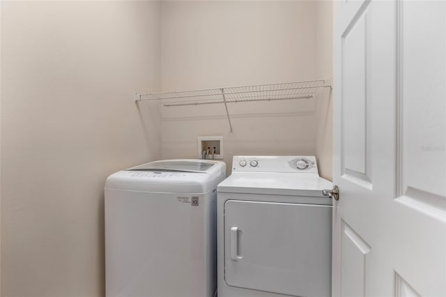 clothes washing area featuring washer and dryer