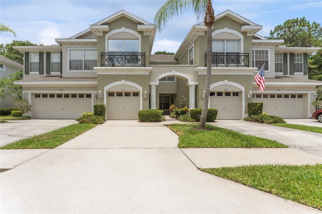 view of front of property featuring a garage and a balcony