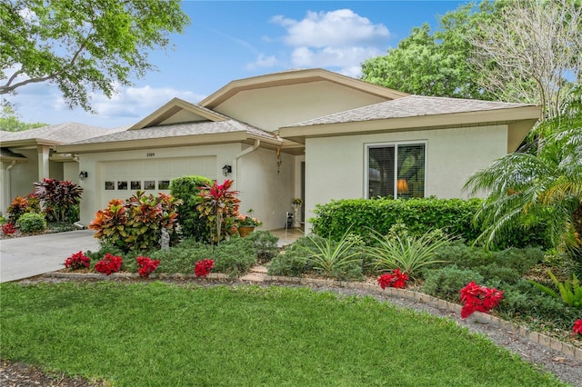 view of front of property with a front lawn and a garage