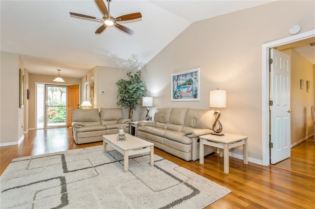 living room featuring ceiling fan, wood-type flooring, and lofted ceiling