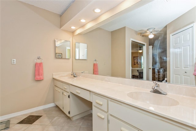 bathroom with vanity, tile patterned floors, ceiling fan, a textured ceiling, and a baseboard radiator