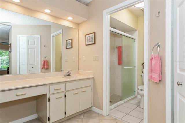 bathroom with toilet, vanity, tile patterned floors, and an enclosed shower