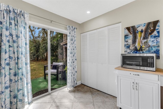 doorway to outside featuring light tile patterned flooring