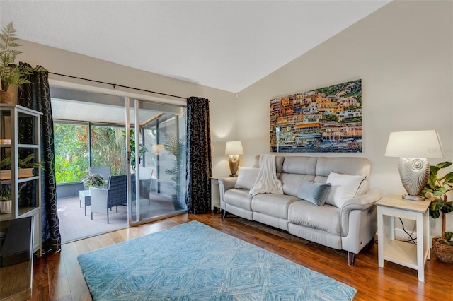 living room featuring vaulted ceiling and hardwood / wood-style flooring