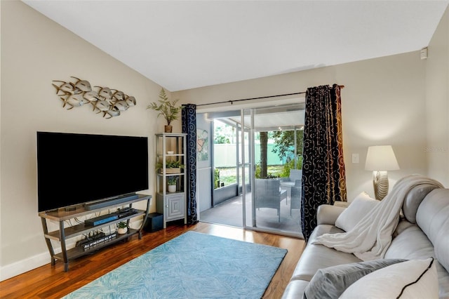 living room with hardwood / wood-style flooring and vaulted ceiling