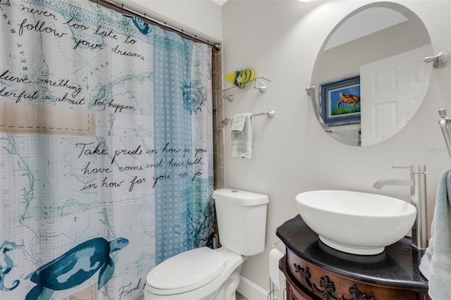 bathroom featuring a shower with curtain, vanity, and toilet