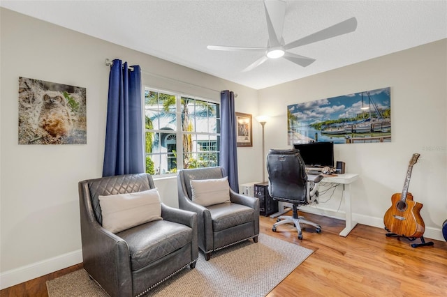 office space with ceiling fan, a textured ceiling, and hardwood / wood-style flooring