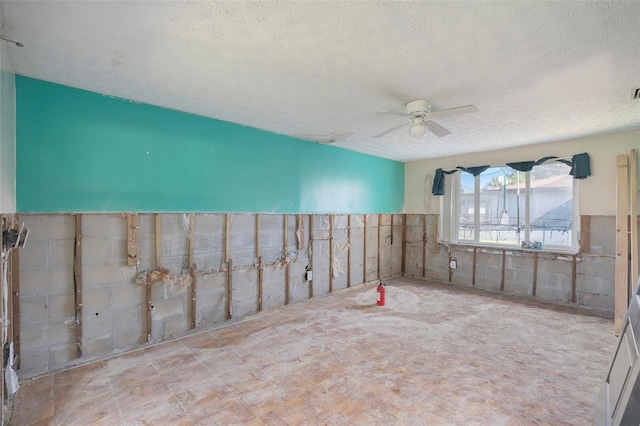 spare room with ceiling fan and a textured ceiling