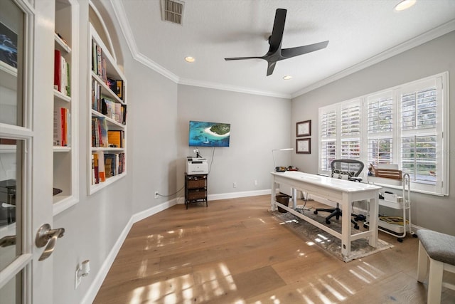 office space featuring hardwood / wood-style floors, ceiling fan, ornamental molding, and a textured ceiling