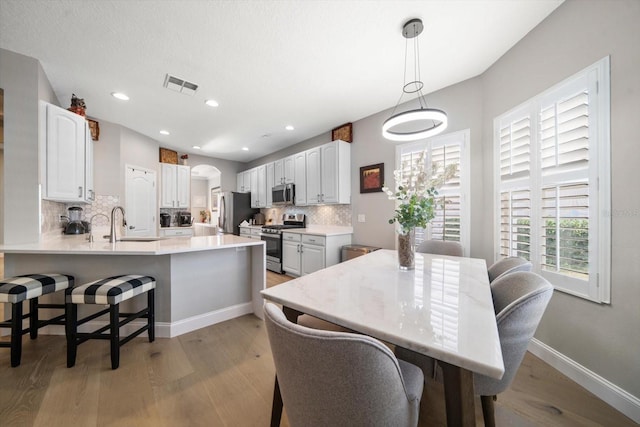 dining room featuring light hardwood / wood-style floors and sink