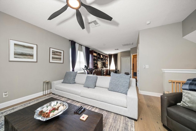 living room featuring ceiling fan and light wood-type flooring