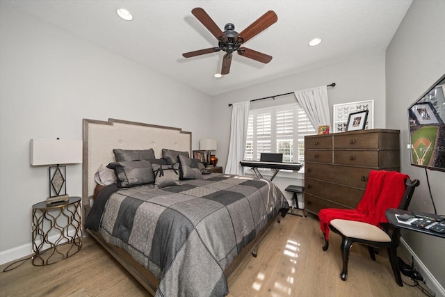 bedroom with light hardwood / wood-style floors and ceiling fan