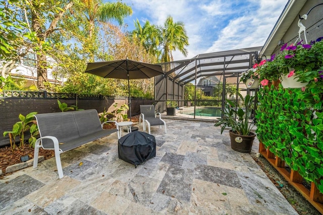 view of patio / terrace with a fenced in pool and glass enclosure