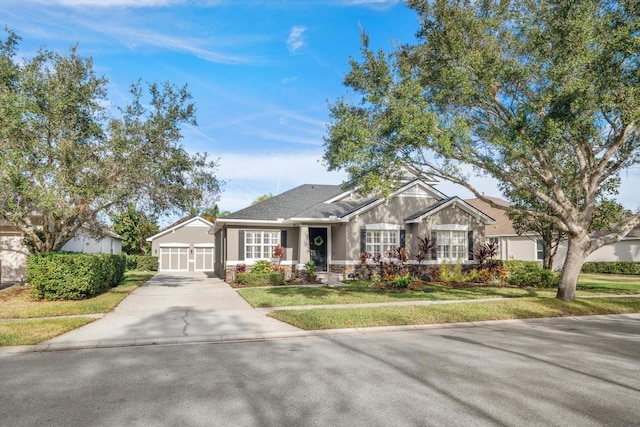 view of front of home with a front lawn, an outdoor structure, and a garage