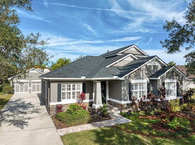 view of front of home with a garage and an outdoor structure