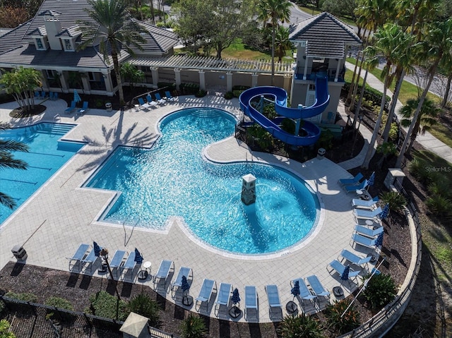 view of swimming pool with a patio and a water slide