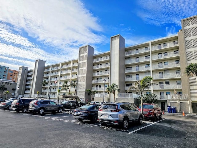 view of building exterior featuring uncovered parking