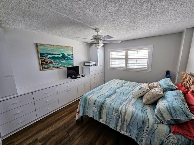 bedroom with a textured ceiling, ceiling fan, and dark wood-type flooring