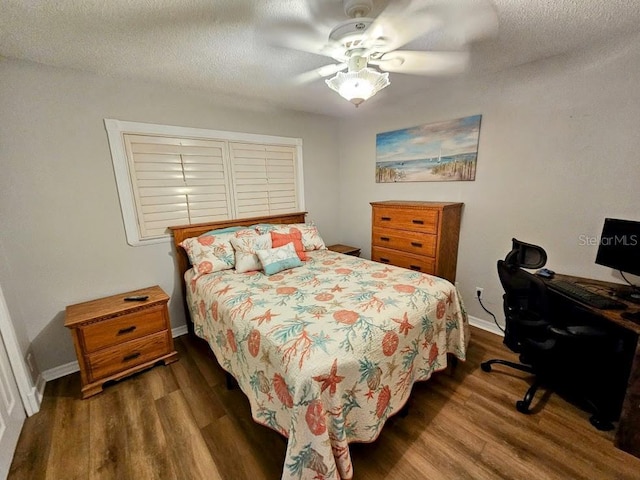 bedroom featuring a textured ceiling, ceiling fan, and dark wood-type flooring