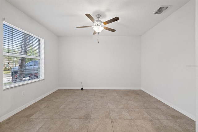 unfurnished room with ceiling fan and light tile patterned floors