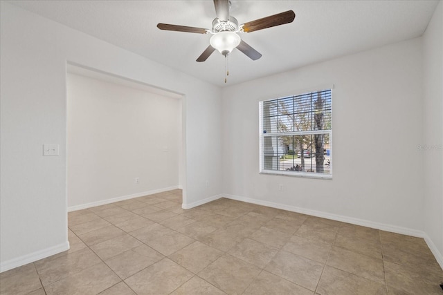 tiled spare room with ceiling fan