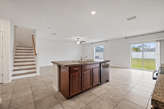 kitchen with a textured ceiling, ceiling fan, sink, a center island with sink, and dishwasher