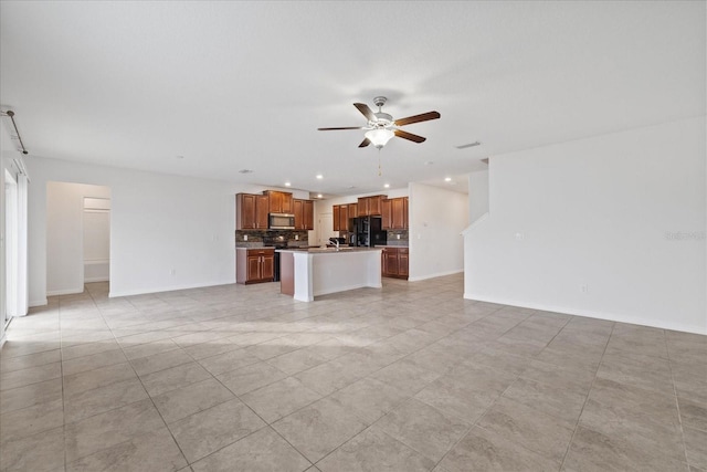 unfurnished living room featuring ceiling fan