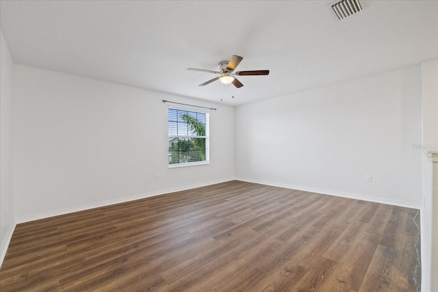 unfurnished room featuring ceiling fan and dark wood-type flooring