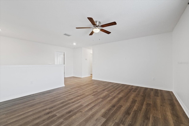 unfurnished room with ceiling fan and dark wood-type flooring