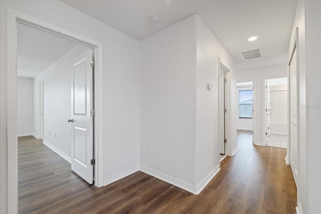 hallway featuring dark hardwood / wood-style flooring