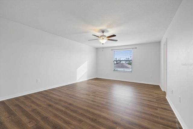 empty room with ceiling fan and dark wood-type flooring