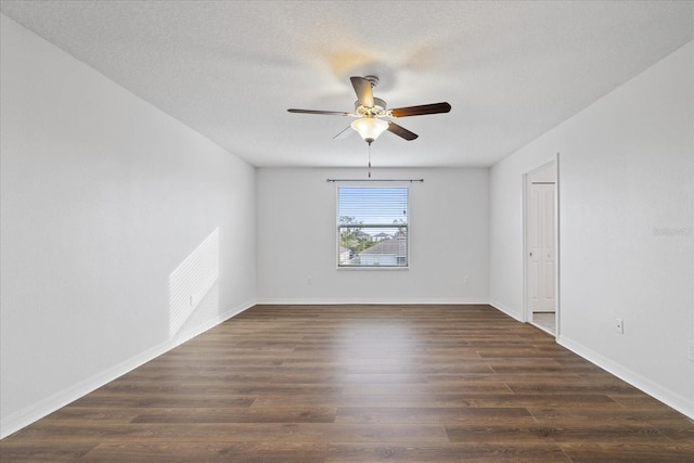 empty room with dark hardwood / wood-style floors and ceiling fan