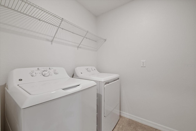 clothes washing area with washer and clothes dryer