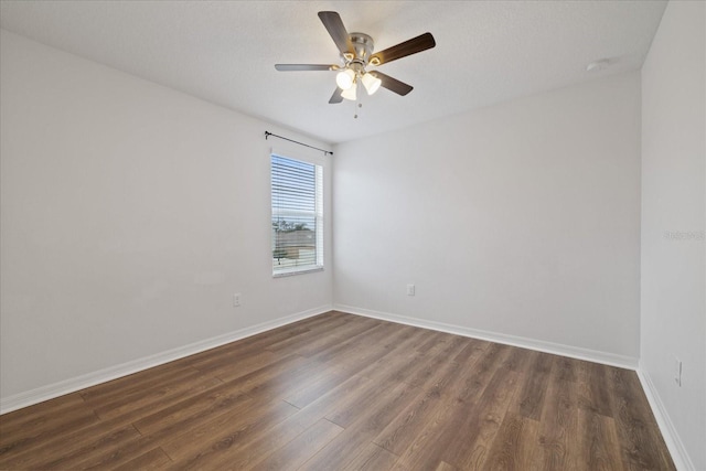 unfurnished room featuring dark hardwood / wood-style flooring and ceiling fan