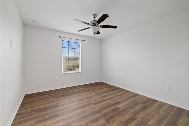 empty room featuring dark hardwood / wood-style floors and ceiling fan