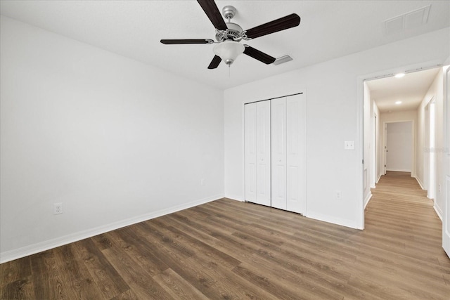 unfurnished bedroom featuring a closet, ceiling fan, and hardwood / wood-style flooring