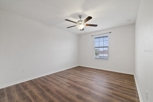 unfurnished room with a textured ceiling, ceiling fan, and dark wood-type flooring