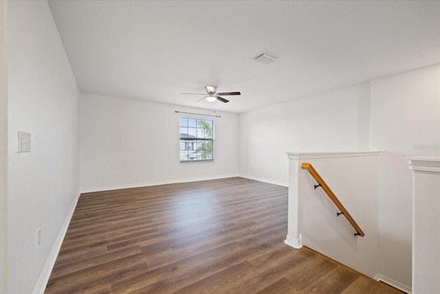 unfurnished room featuring ceiling fan and dark hardwood / wood-style flooring