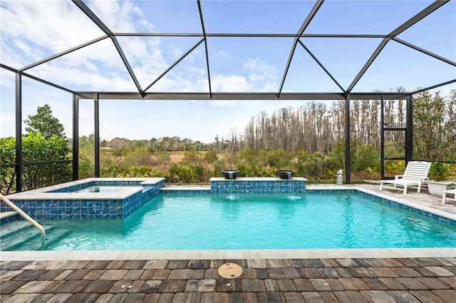 view of pool with an in ground hot tub, a lanai, pool water feature, and a patio