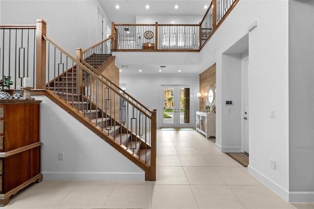 tiled entryway with french doors and a high ceiling